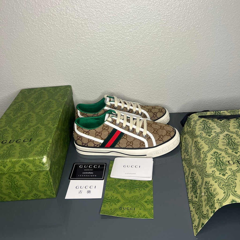 Gucci sneakers with packaging on a gray surface