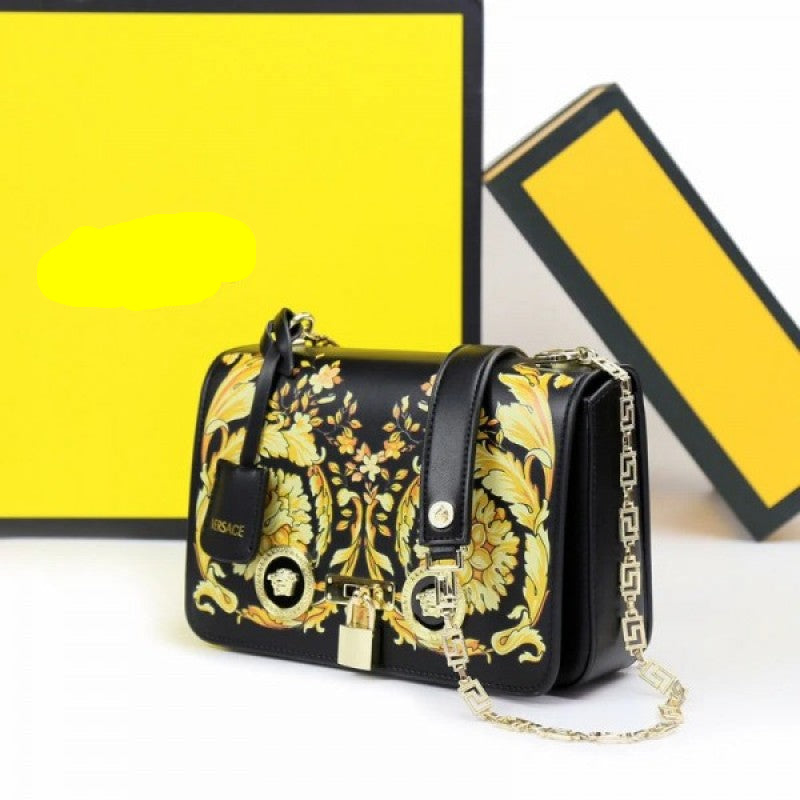Flower medusa Versace handbag with gold and black design on a yellow background