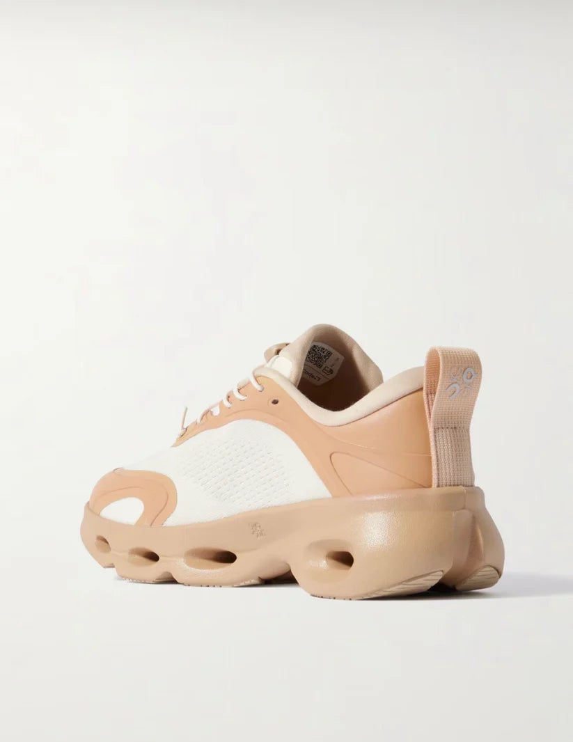 Beige and white sneaker on a light gray background