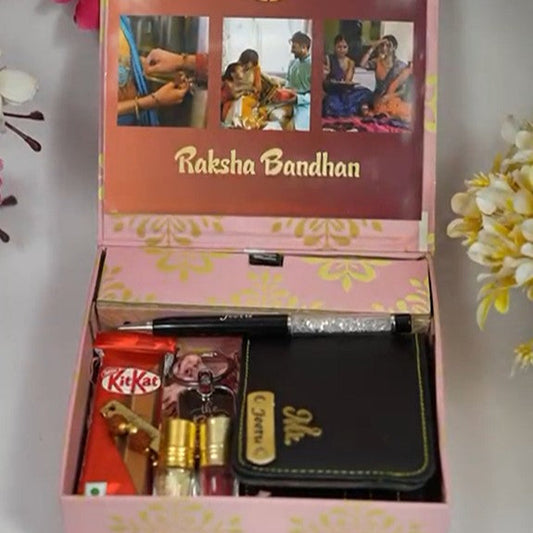 Gift box with Raksha Bandhan theme, containing a wallet, KitKat, and other items, on a white background.