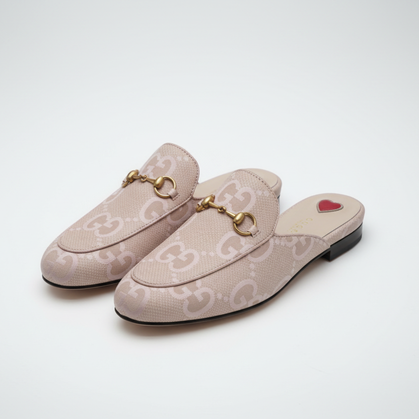 Beige GUCCI Women Mules loafers with gold accents and red hearts on a white background