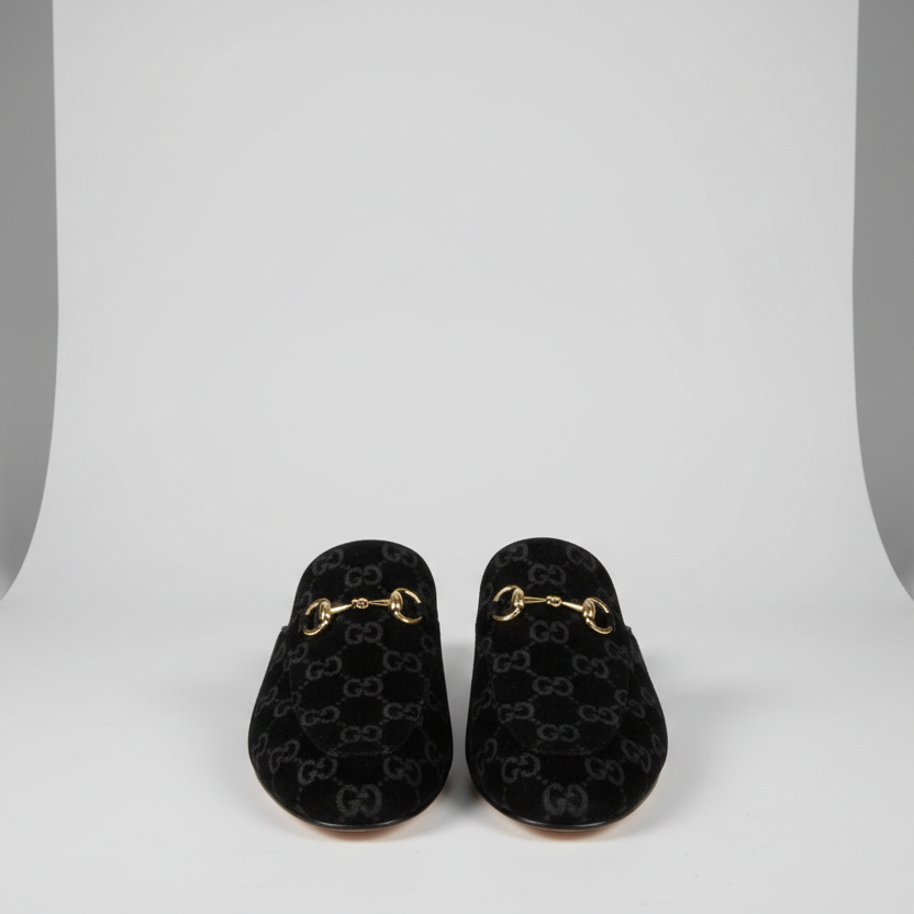 Black GUCCI Women Mules Pair of black Gucci loafers on a light gray background