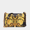 Flower medusa Versace handbag with gold floral design on a light gray background