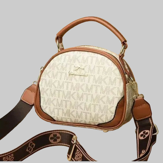 Designer handbag with monogram pattern on a peach background