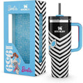 Stanley mug with black and white chevron pattern and blue handle, next to Barbie-themed packaging.