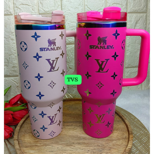 Two insulated mugs with Louis Vuitton and Stanley branding on a textured surface.