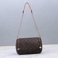 Brown monogram handbag with chain strap on a light gray background