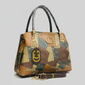 Multicolored handbag with gold accents and Gucci logo on a blurred background