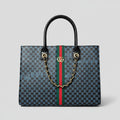 Blue Gucci Structured Tote Bag Person holding a Gucci handbag with a visible brand logo on a white background