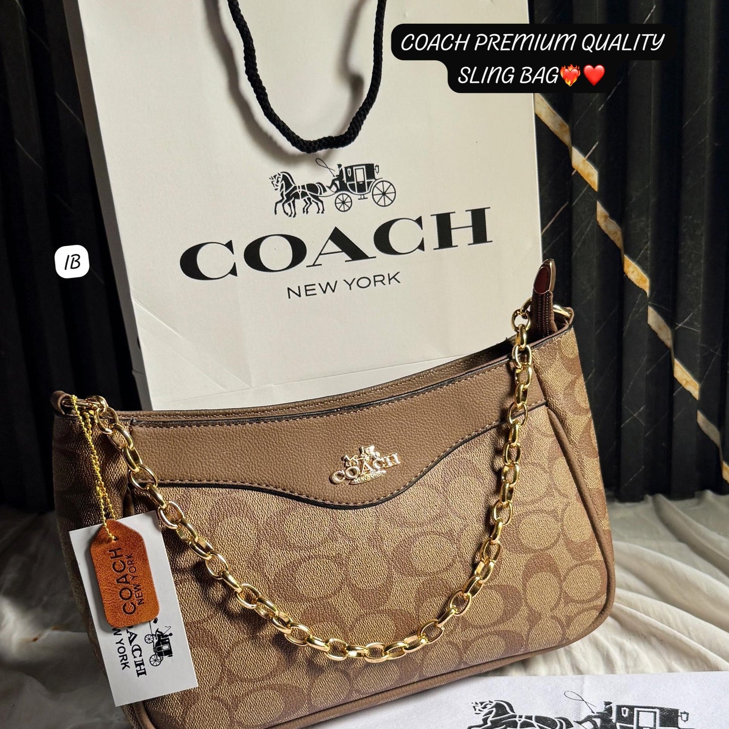 Coach handbag with gold chain and Coach branded paper bag on a dark background