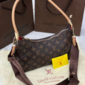 Louis Vuitton handbag with monogram pattern on a white surface with a brown Louis Vuitton box in the background.
