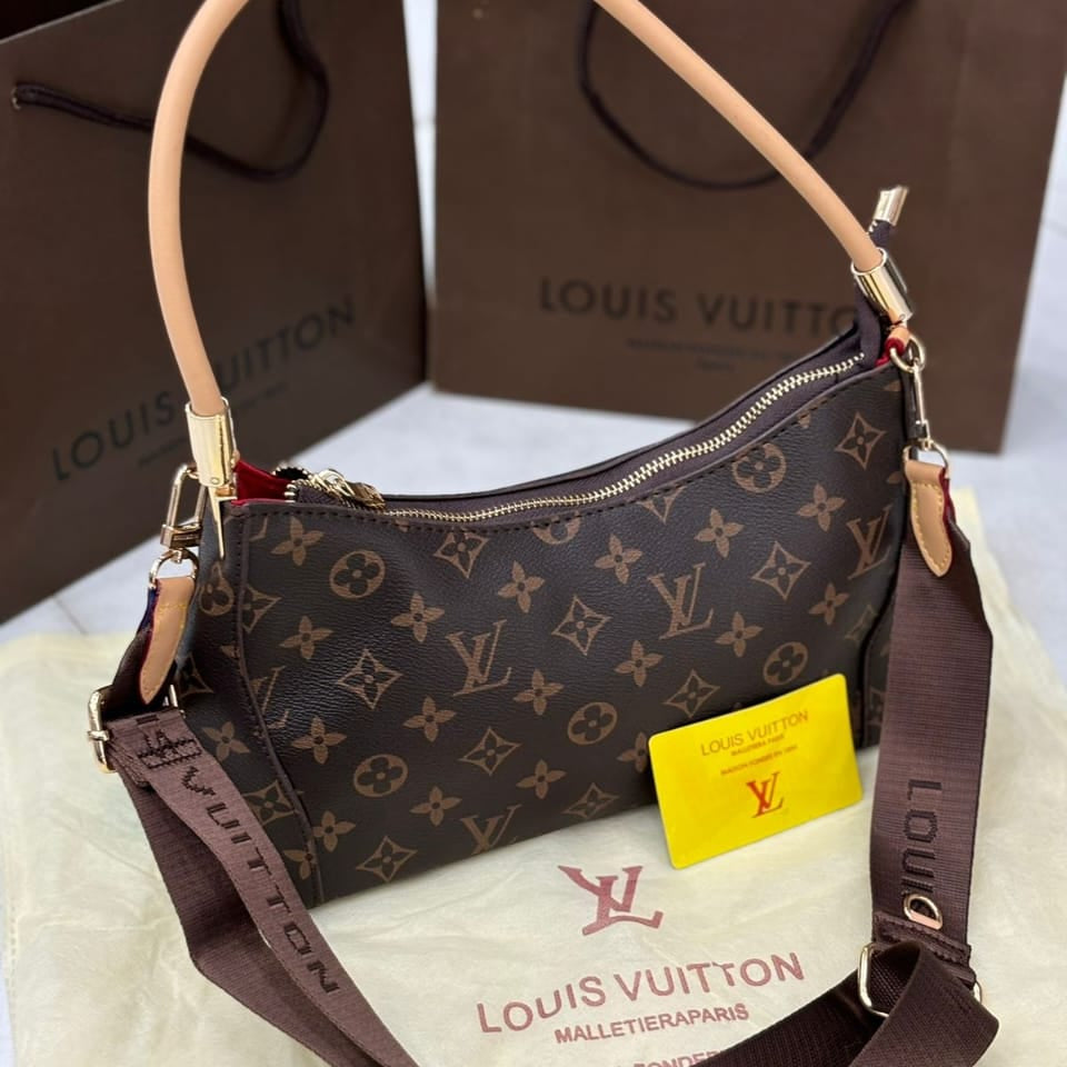 Louis Vuitton handbag with monogram pattern on a white surface with a brown Louis Vuitton box in the background.