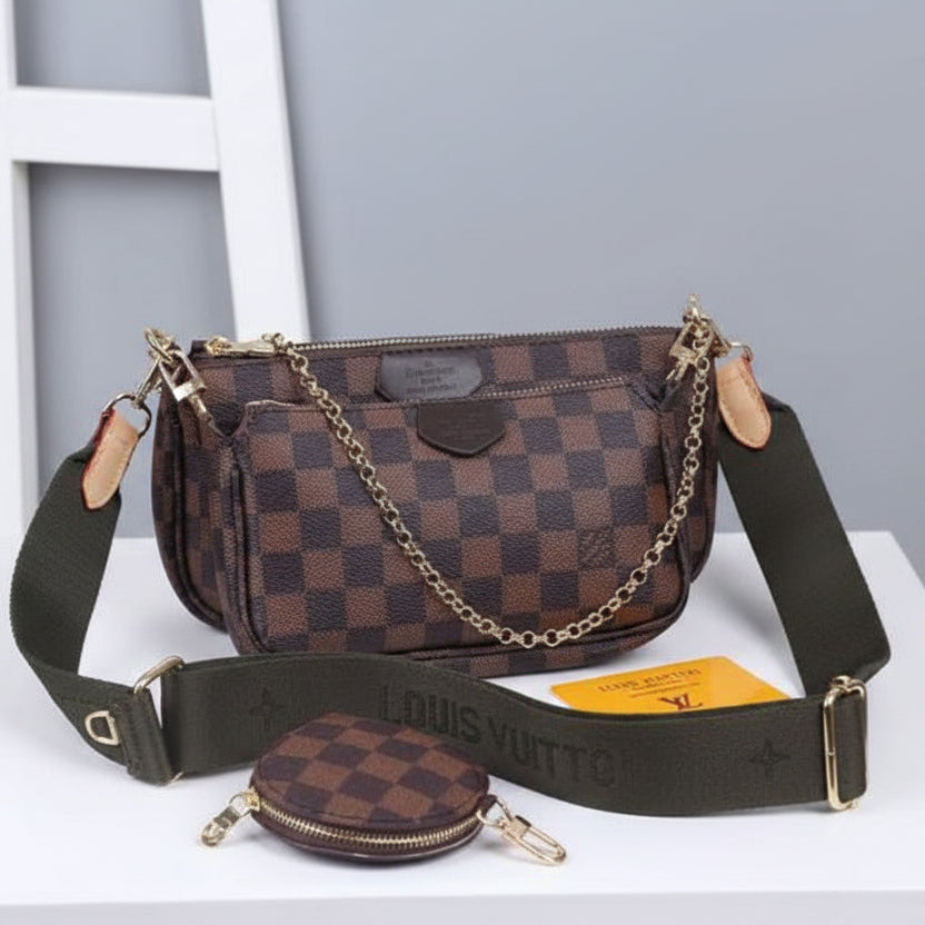 Brown checkered handbag with matching pouch on a white surface against a gray background