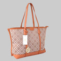 Patterned handbag with brown accents on a light surface, blurred background