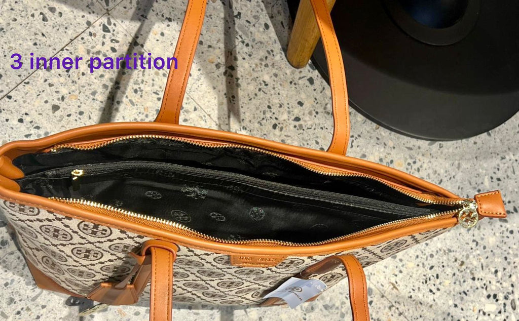 Handbag with interior view showing three inner partitions on a textured surface.
