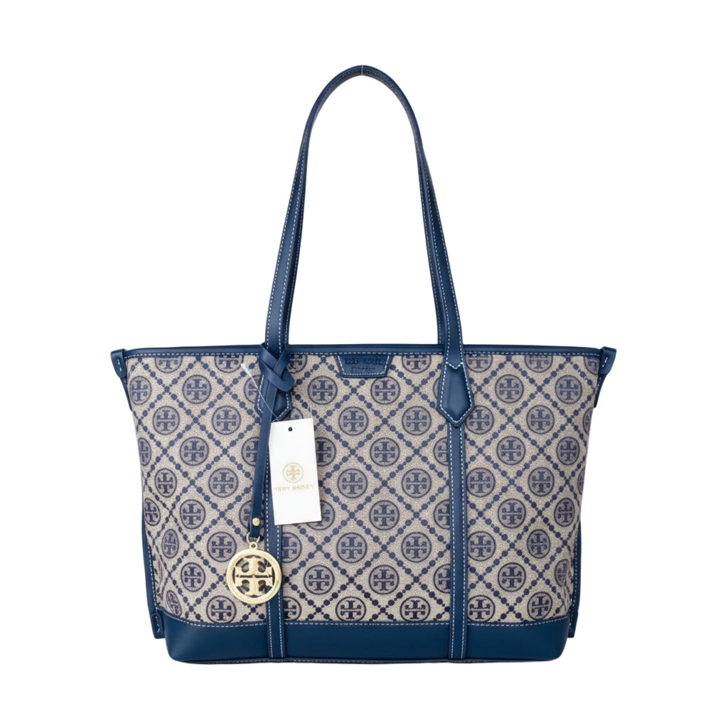 Blue and white patterned handbag with a visible brand tag on a light surface.