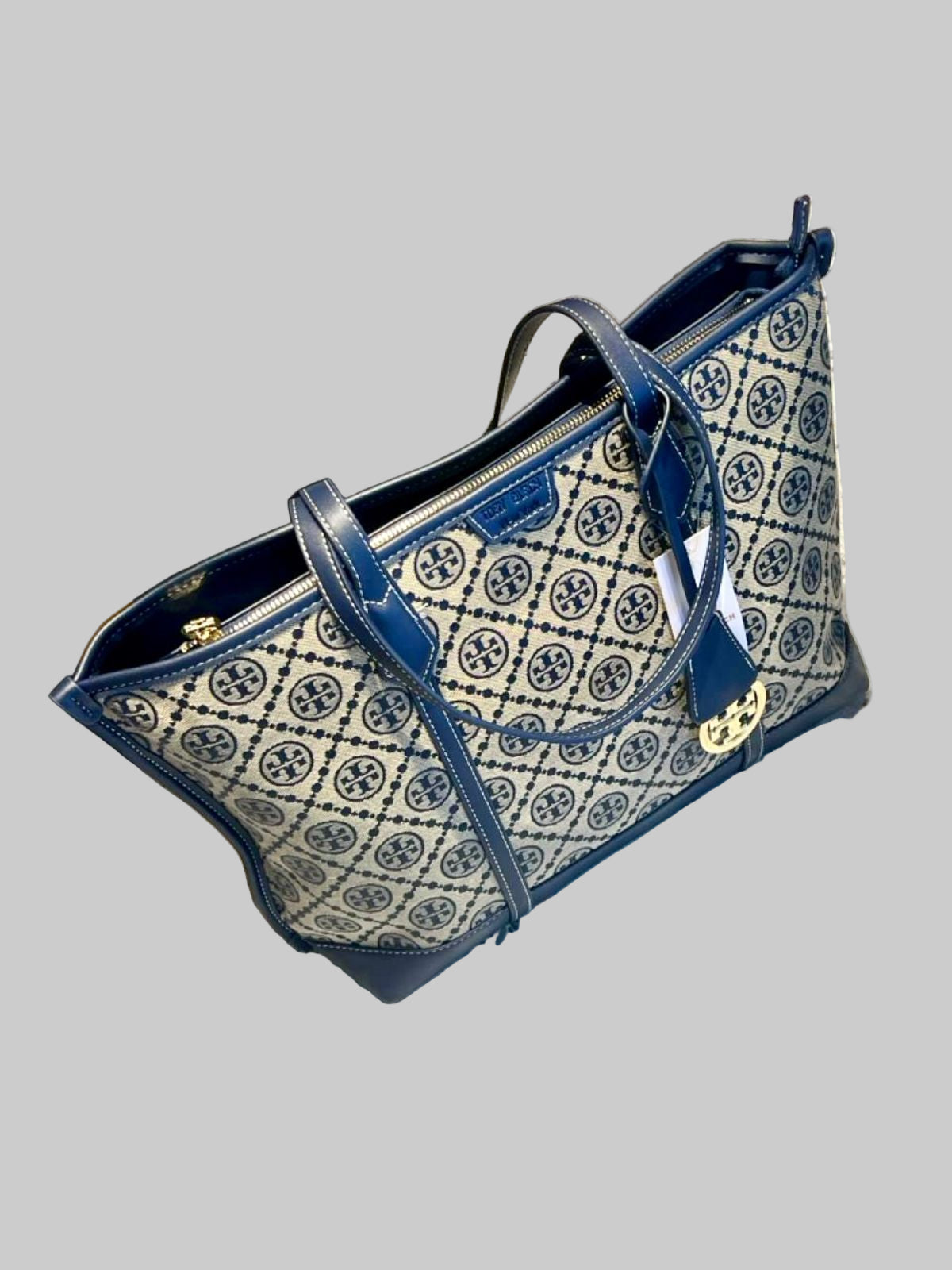 Blue and white patterned handbag on a textured surface
