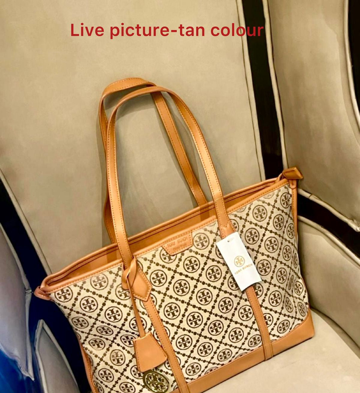 Tan and patterned handbag with a visible brand logo on a car seat.