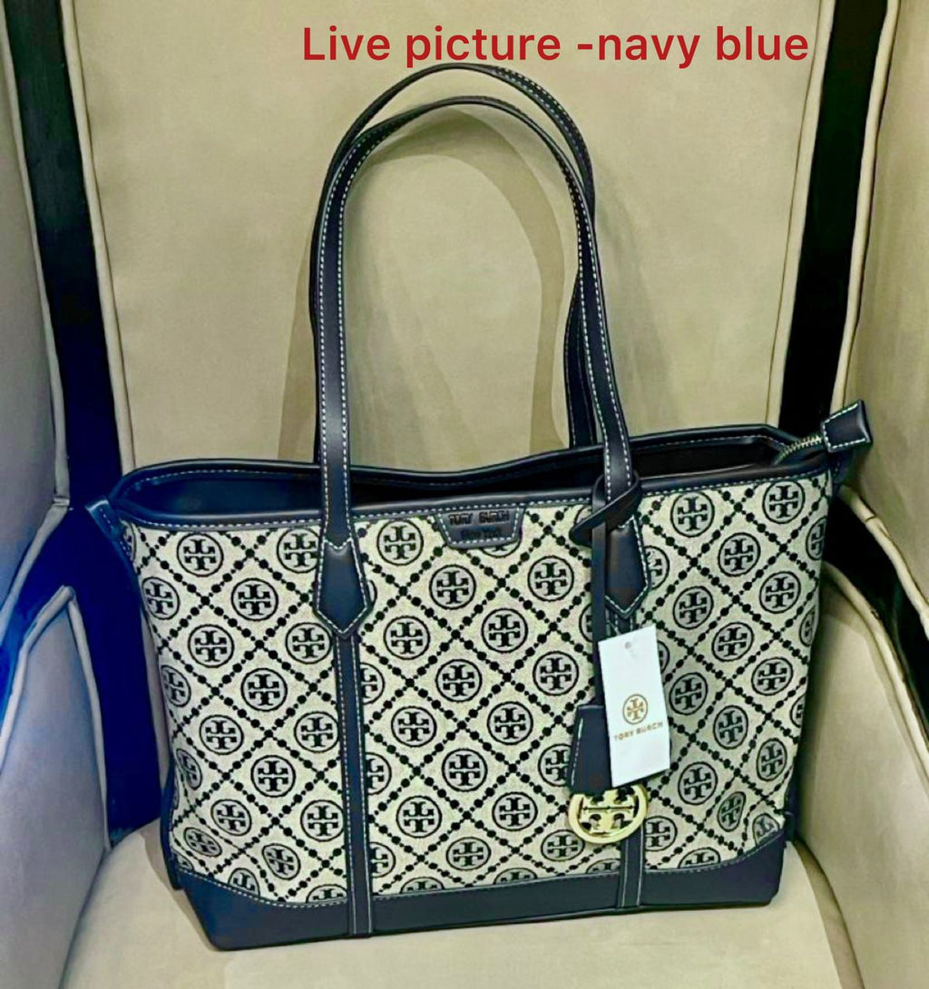 Navy blue handbag with a patterned design on a beige background