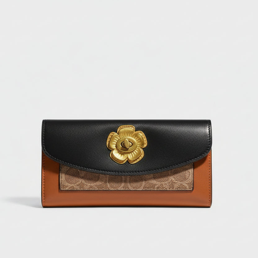 Coach wallet with gold emblem in a box on a speckled surface