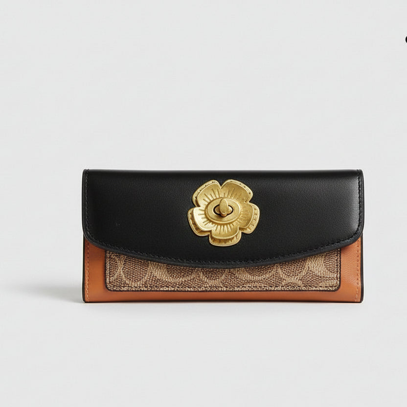 Coach wallet with floral emblem on a white surface