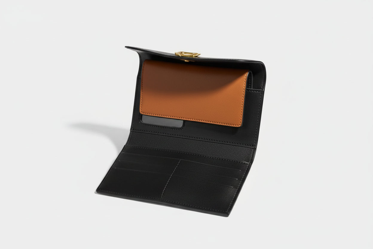 Black leather wallet with a brown interior on a wooden surface, with 'Coach' branding in the background.