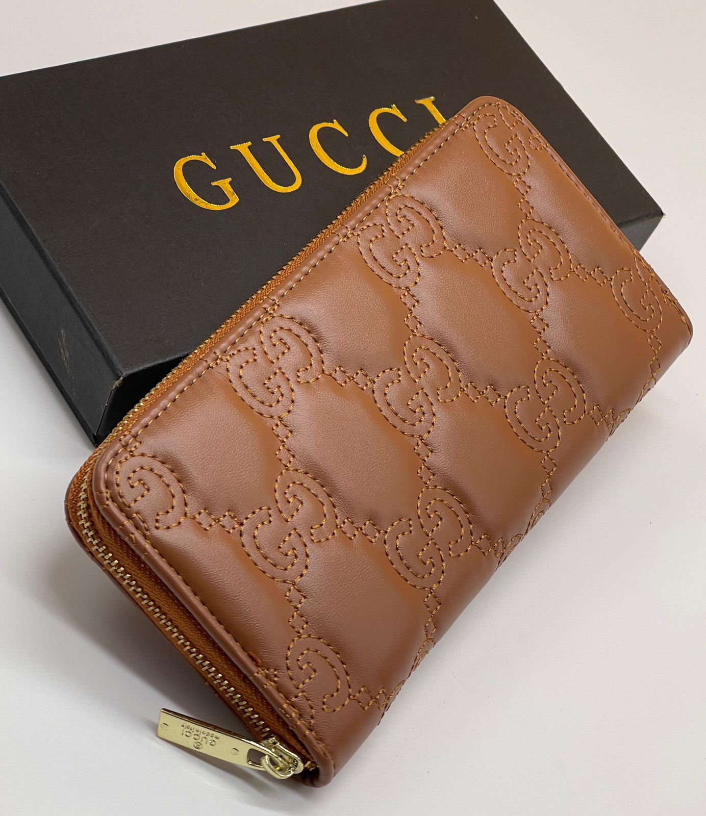 Brown Luxury Gucci Women’s Long Wallet leather wallet with embossed pattern on a Gucci box