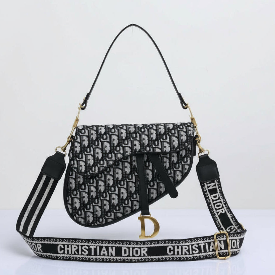 Christian Dior handbag with monogram pattern and branded strap on a white background