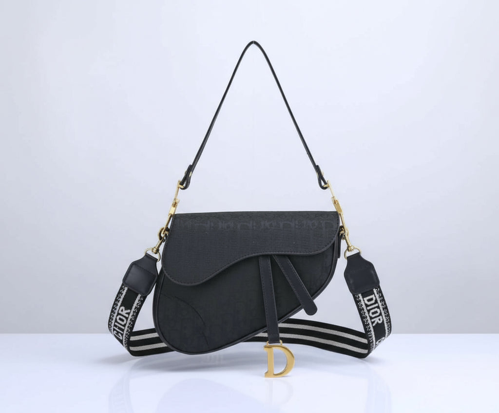 Black handbag with a branded strap on a white background