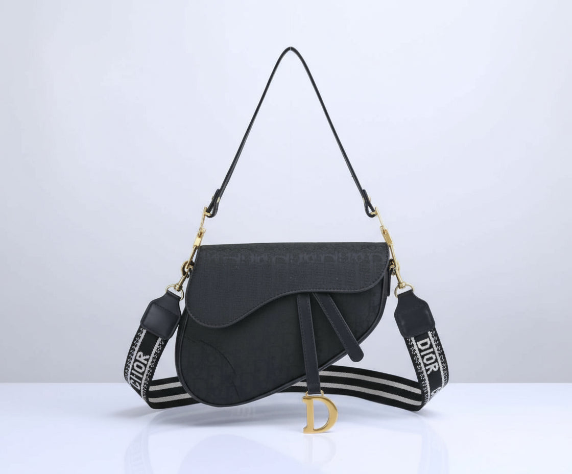 Black handbag with a branded strap on a white background