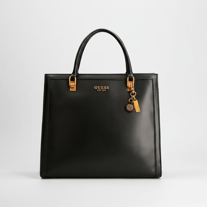 Black handbag with gold accents and Guess logo on a white background