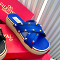 Blue studded sandal on a red Valentino box