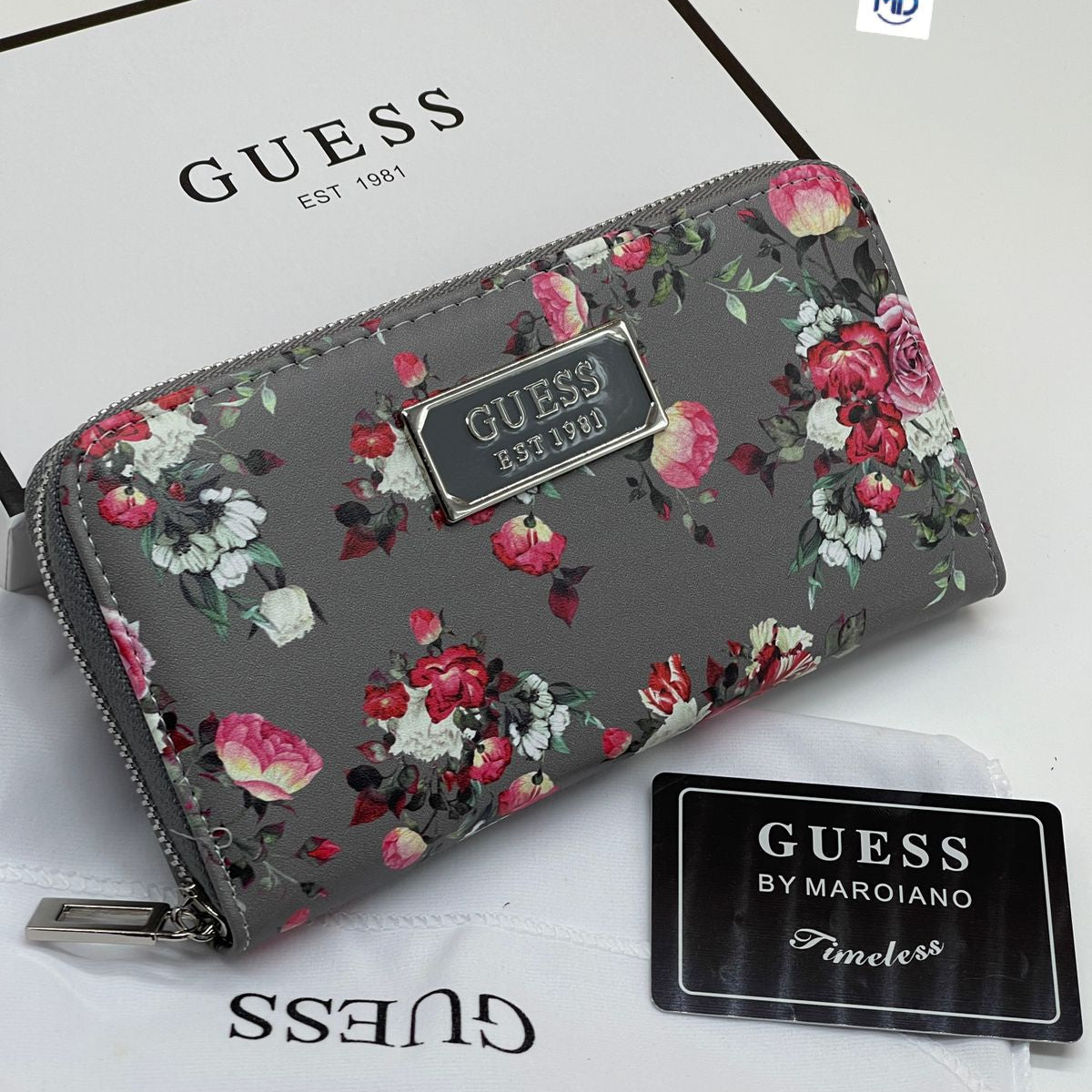 Grey Guess Women’s Long Wallet Floral-patterned wallet with Guess branding on a white surface