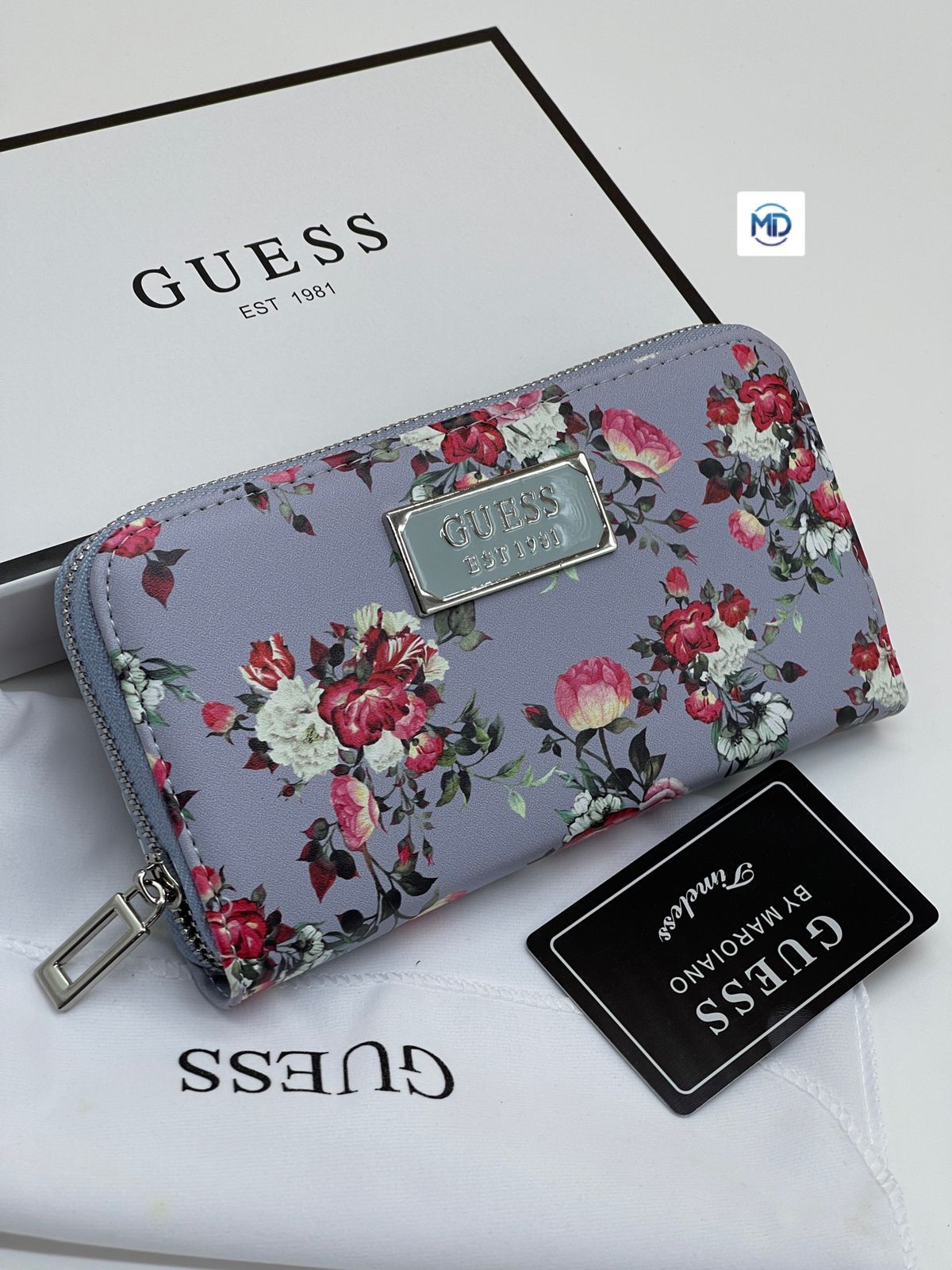 Purple Guess Women’s Long Wallet Floral-patterned wallet with Guess branding on a white surface