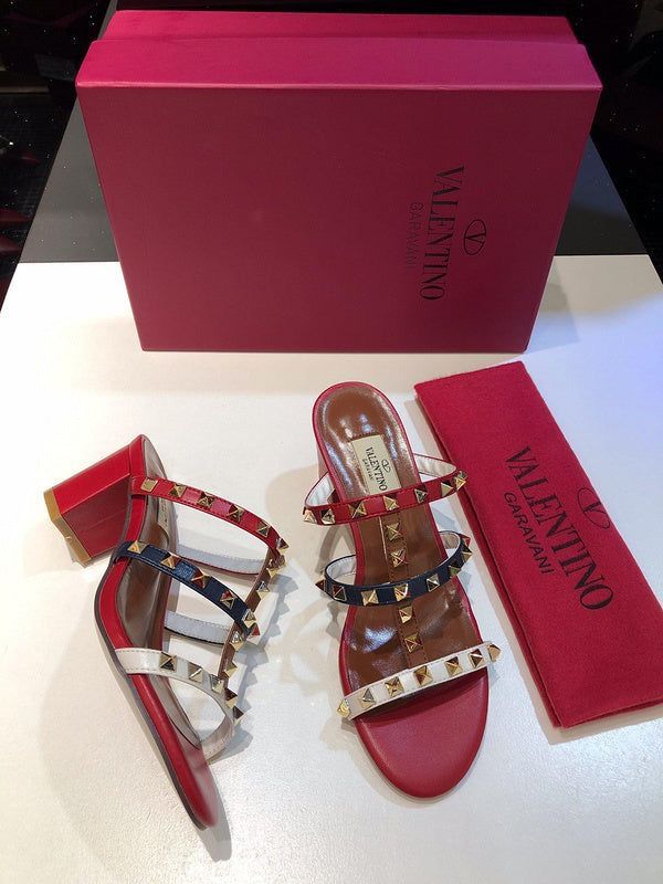 Valentino sandals with studded design and matching pink box on a white background