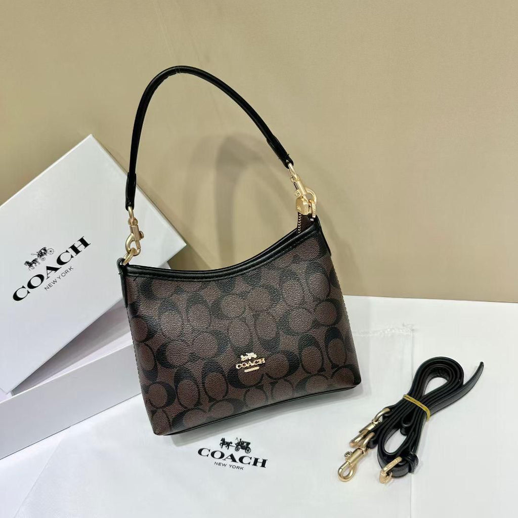 Tan Coach Tabby Handbag Coach handbag with matching strap on a beige background