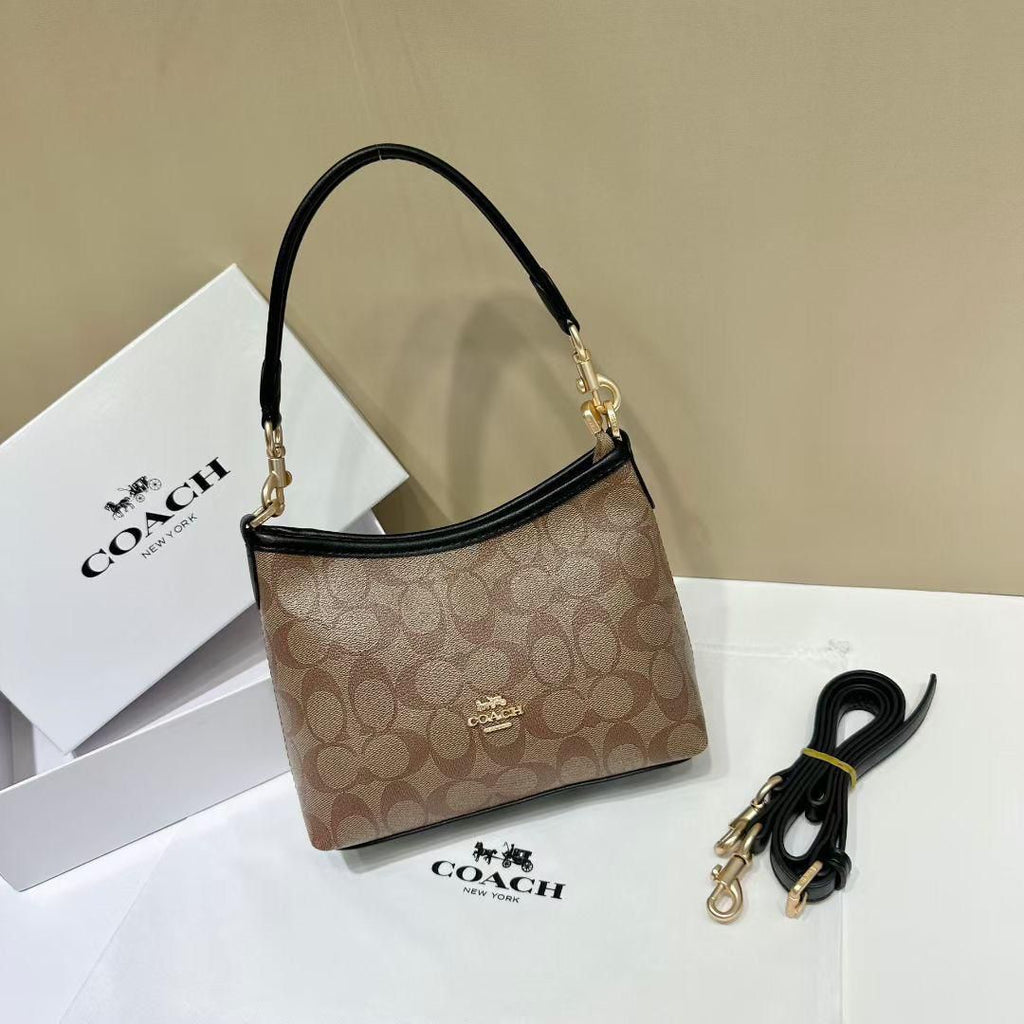 Beige Coach Tabby Handbag Coach handbag with black handle and strap on a beige background