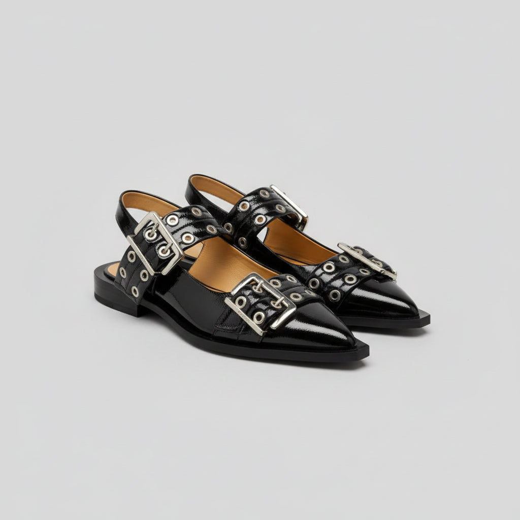 Black CHLOÉ Western Look Footwear patent leather shoes with silver buckles on a surface with books underneath
