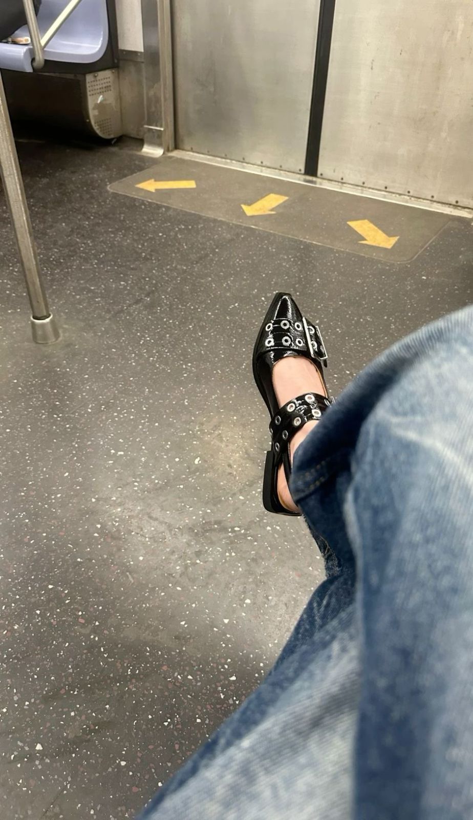 Black CHLOÉ Western Look Footwear  Person wearing black high-heeled shoes with studded details on a subway floor.