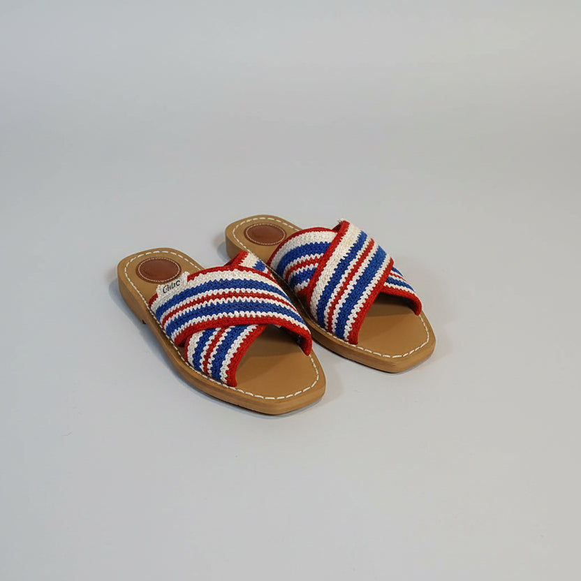 Navy Blue Chloe sandals with brown soles on a Chloe branded surface