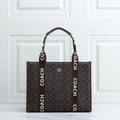 Tan Coach Large Smith Tote Bag Coach tote bag with logo straps on a white surface
