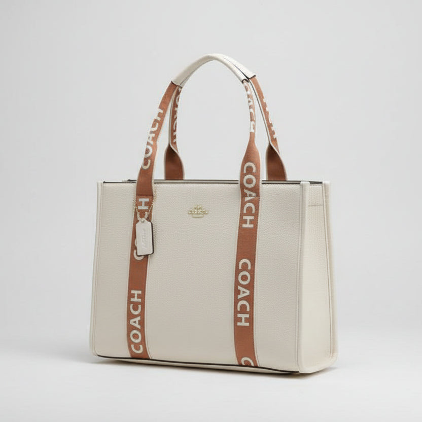 Coach Large Smith Tote Bag handbag with brown straps on a marble surface