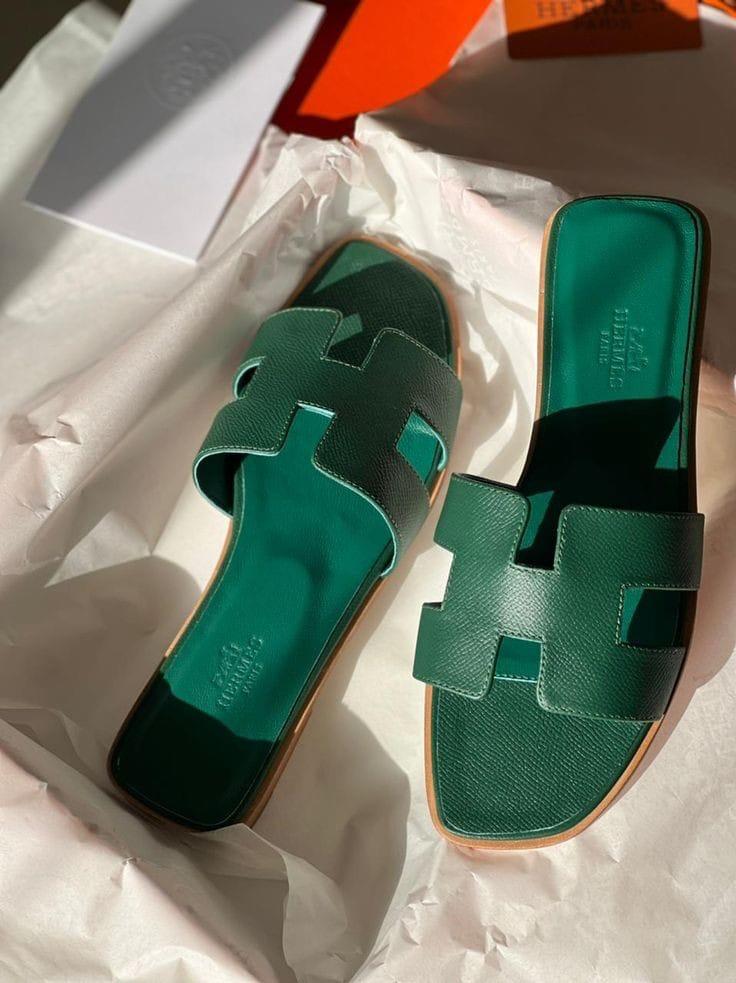 Green HERMES Oran Velvet women  sandals with a distinctive strap design on a white background