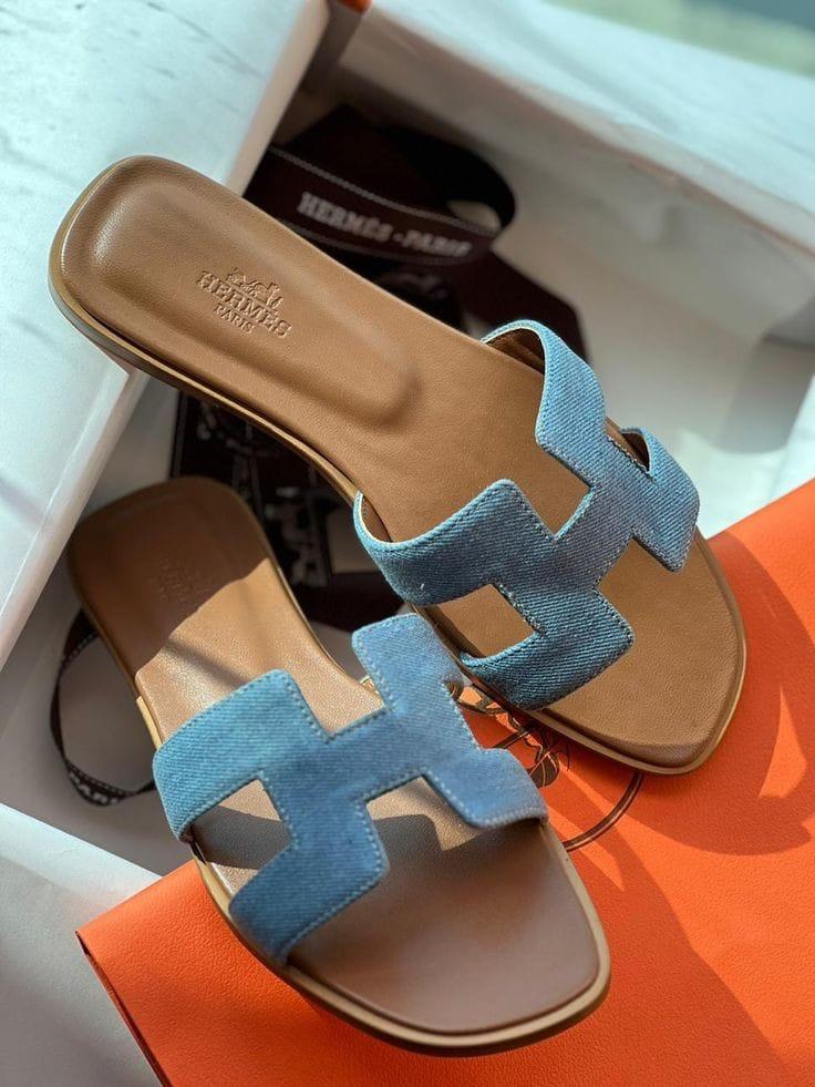 Blue HERMES Oran Velvet women  sandals with brown soles on an orange surface