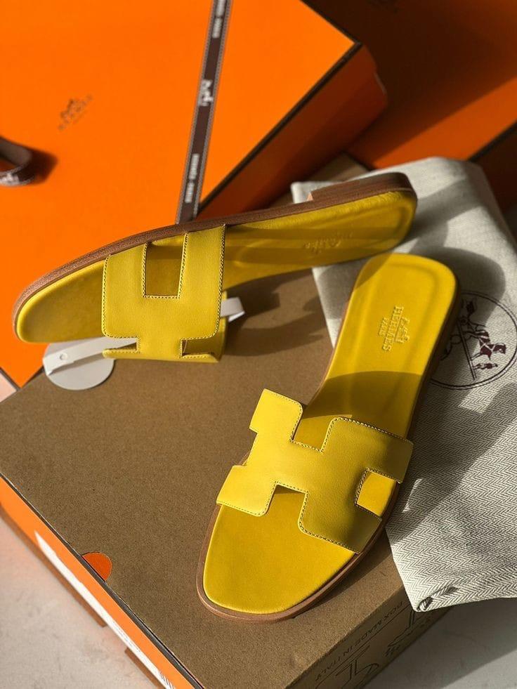Yellow White HERMES Oran Velvet women heels sandals with a brand logo on an orange and brown box.