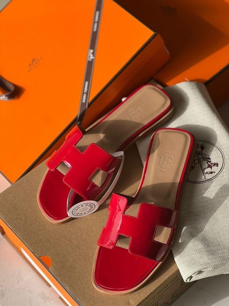 Red  HERMES Oran Velvet women heels sandals with a visible brand logo on an orange box