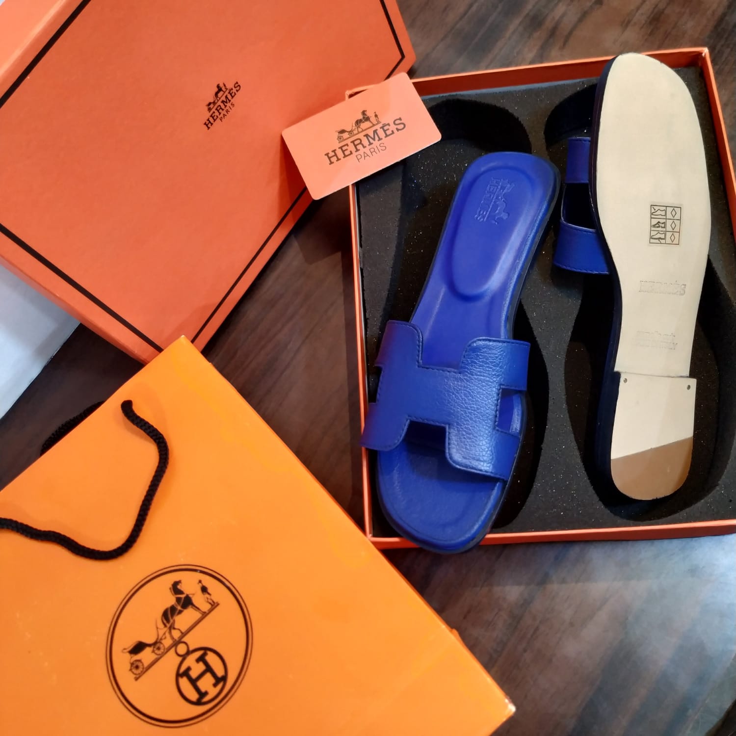 Blue  HERMES Oran Velvet women heels sandal with insole in an open Hermès box, with Hermès branding visible.