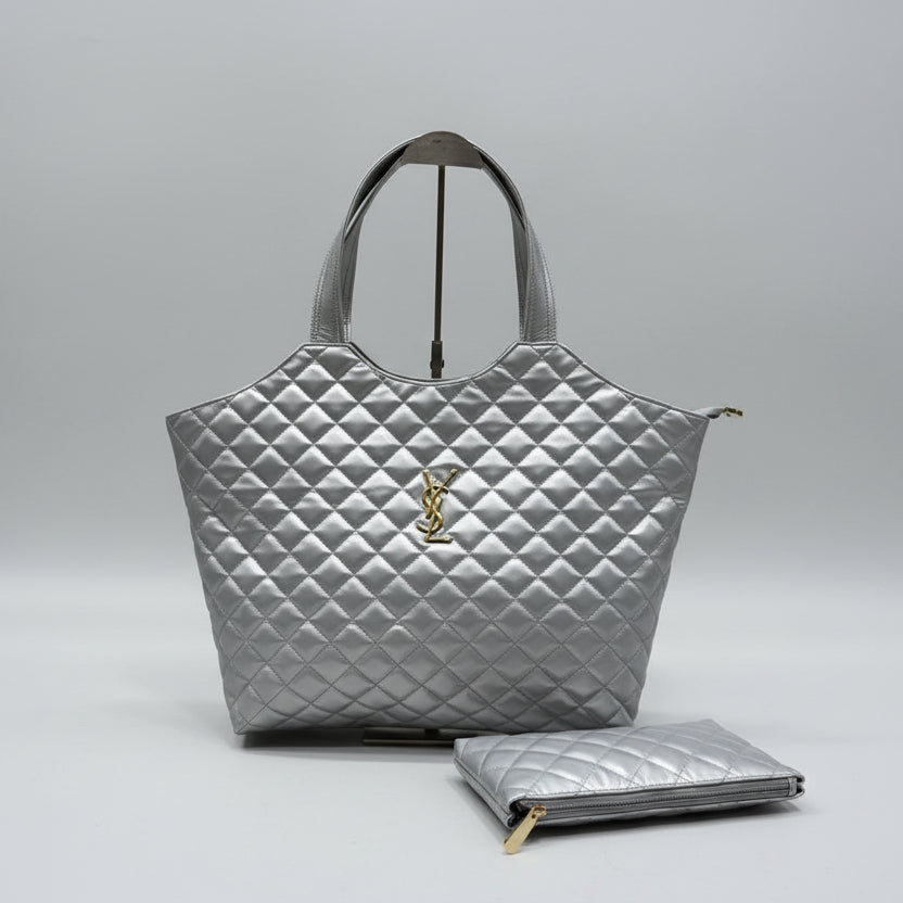 Silver YSL Big Size Tote Bag with Small Wallet handbag with a matching clutch on a wooden surface.