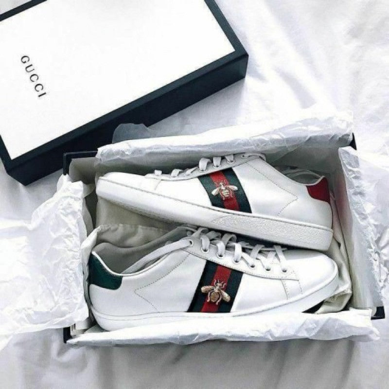 White Gucci sneakers with red and green bee stripes in a box