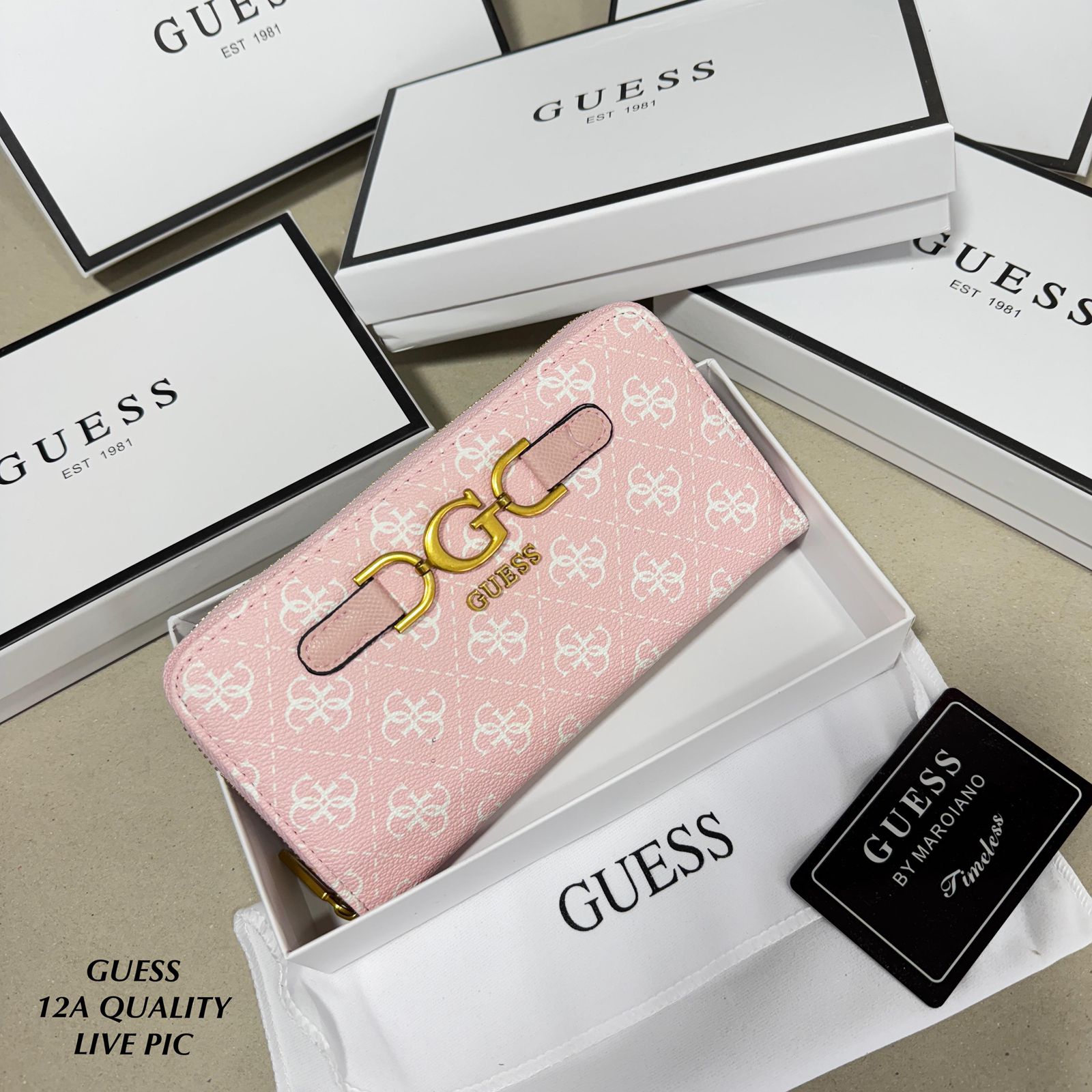 Pink Premium Guess Big Size Zipper Wallet Pink Guess wallet with gold logo on a beige surface with Guess branding.